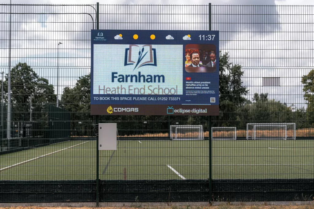 LED digital screen overlooking the all-weather sports pitches at Farnham Heath End School