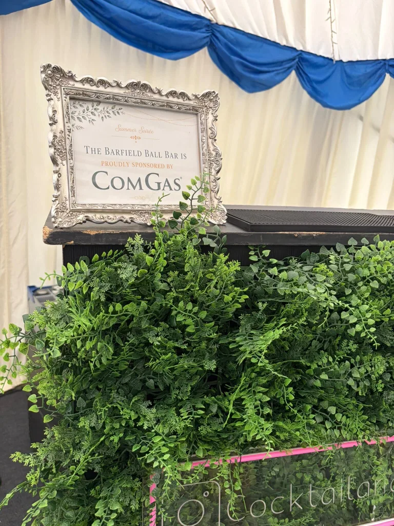ComGas sponsor sign on the foliage-fronted bar at the Barfield Summer Ball