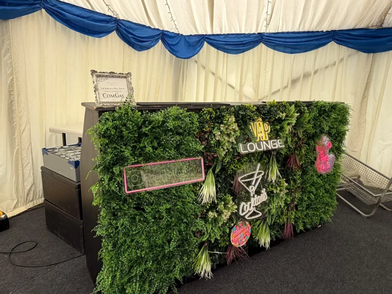 Foliage-fronted bar inside the marquee at the Barfield Summer Ball, sponsored by ComGas