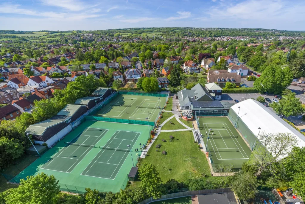 Aerial view of Bourne Club showing the clubhouse, tennis courts and surrounding grounds