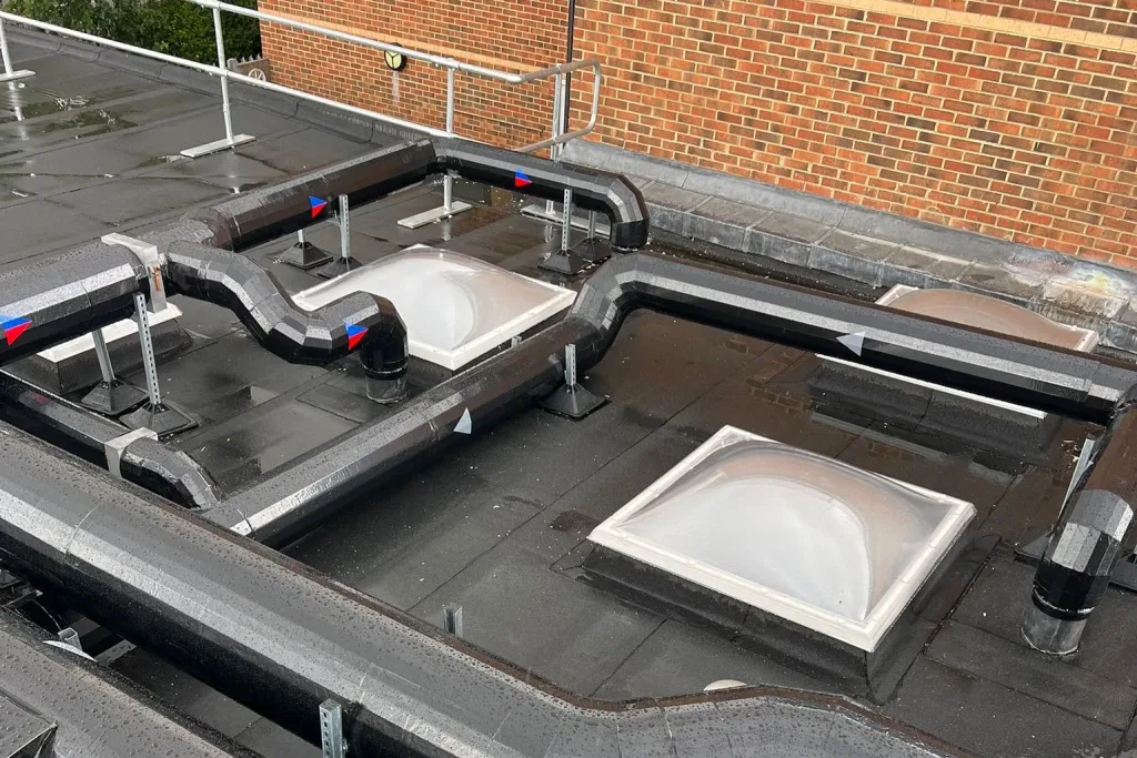Finished insulated rooftop ductwork coordinated around rooflights at Didcot