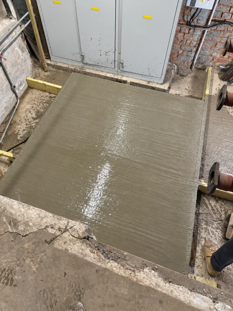 Newly formed concrete equipment base prepared for the new boiler plant