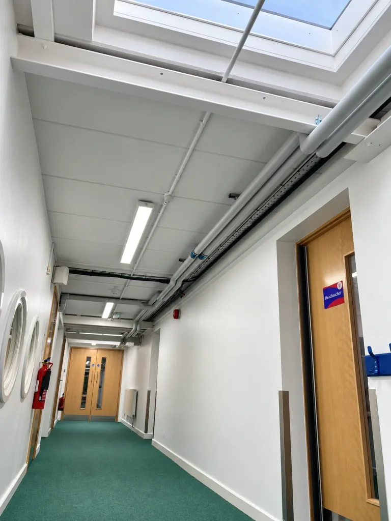 Reinstated corridor services beneath a rooflight after the steel reinforcement was completed