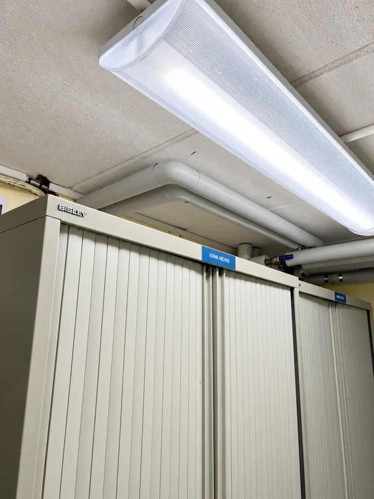 Heating pipework routed at high level above fitted storage cupboards