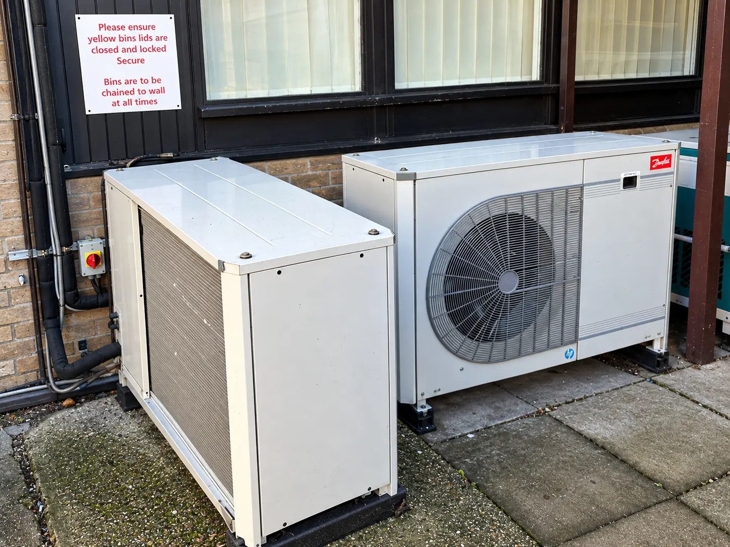 Two existing outdoor condenser units before decommissioning.