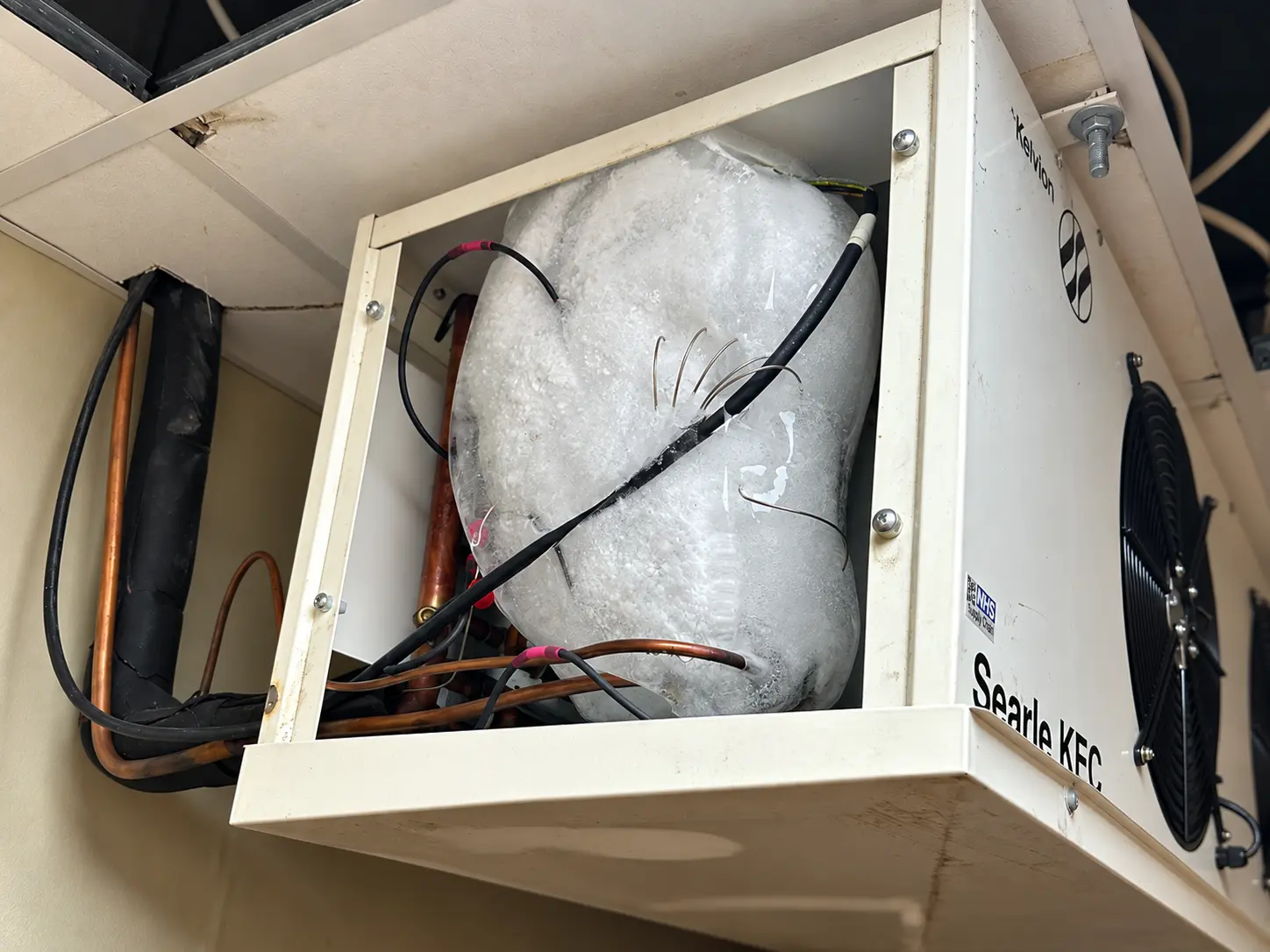 Ice build-up inside an existing blower-coil assembly before decommissioning.