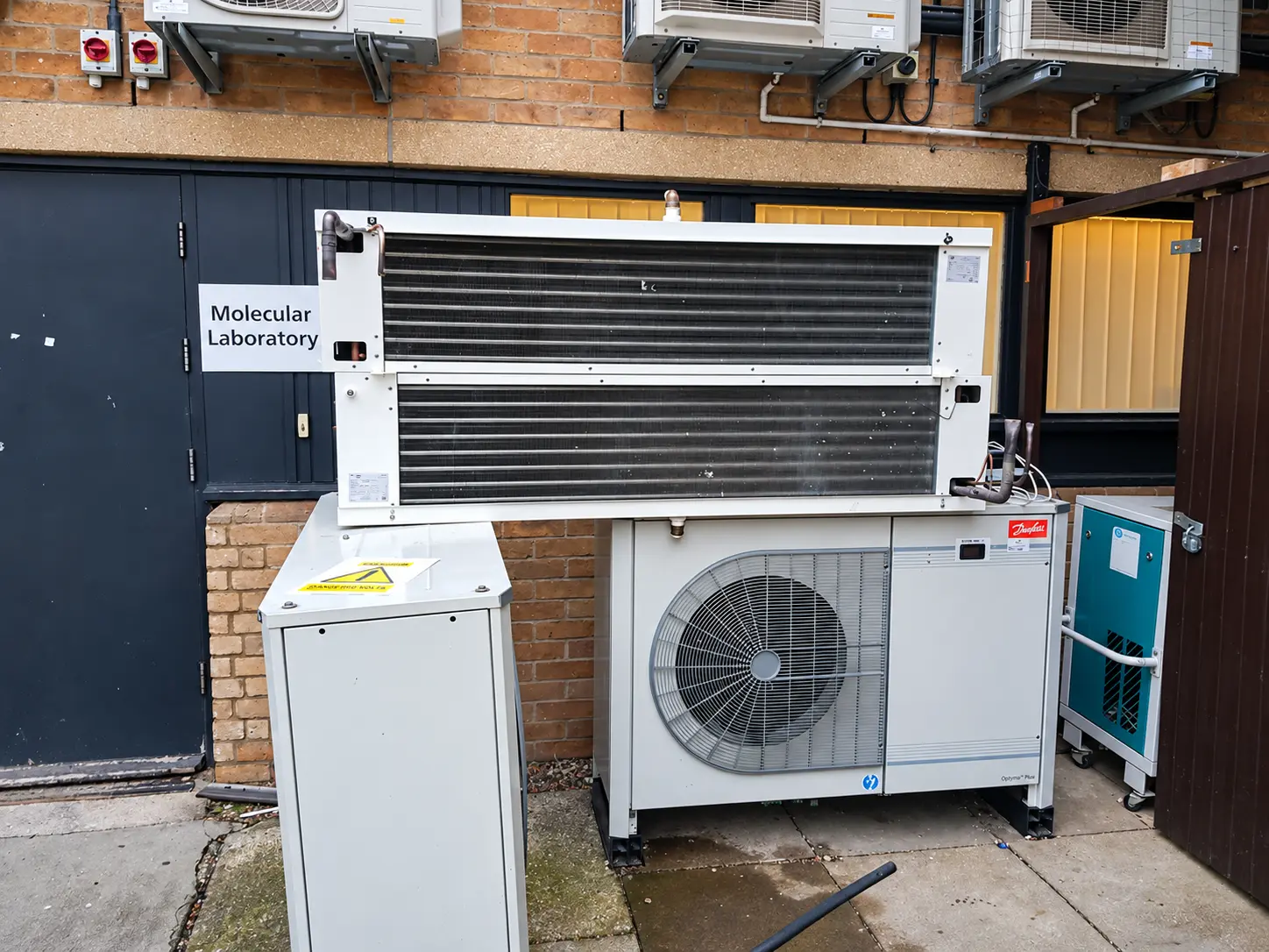 Decommissioned refrigeration equipment grouped during the removal process.